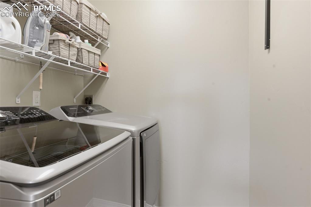 Image 18 of 50: Kitchen with stainless steel appliances, wood finish cabinetry, a breakfast