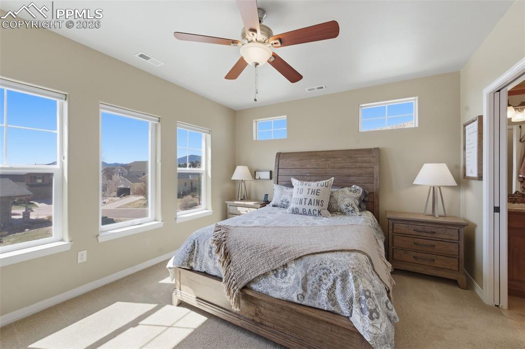 Image 21 of 50: Kitchen view of backsplash, light stone countertops, and wood finish cabine
