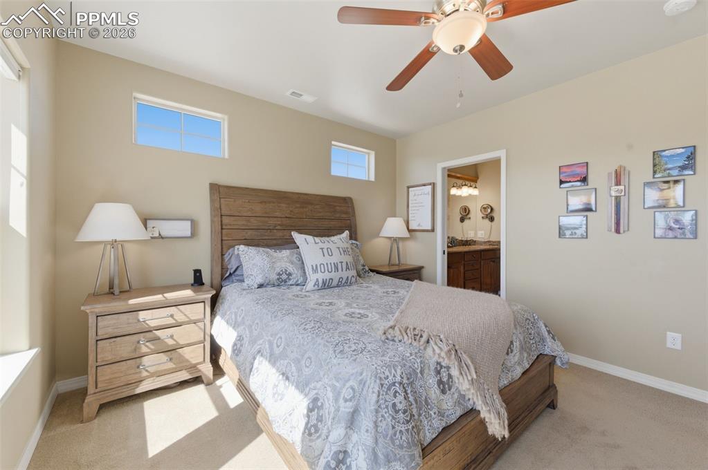 Image 23 of 50: Workout area featuring light carpet and a chandelier