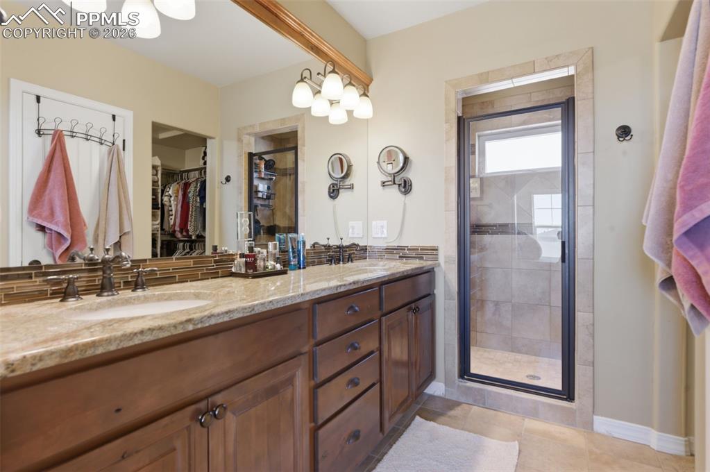 Image 25 of 50: Bedroom with ceiling fan and light colored carpet