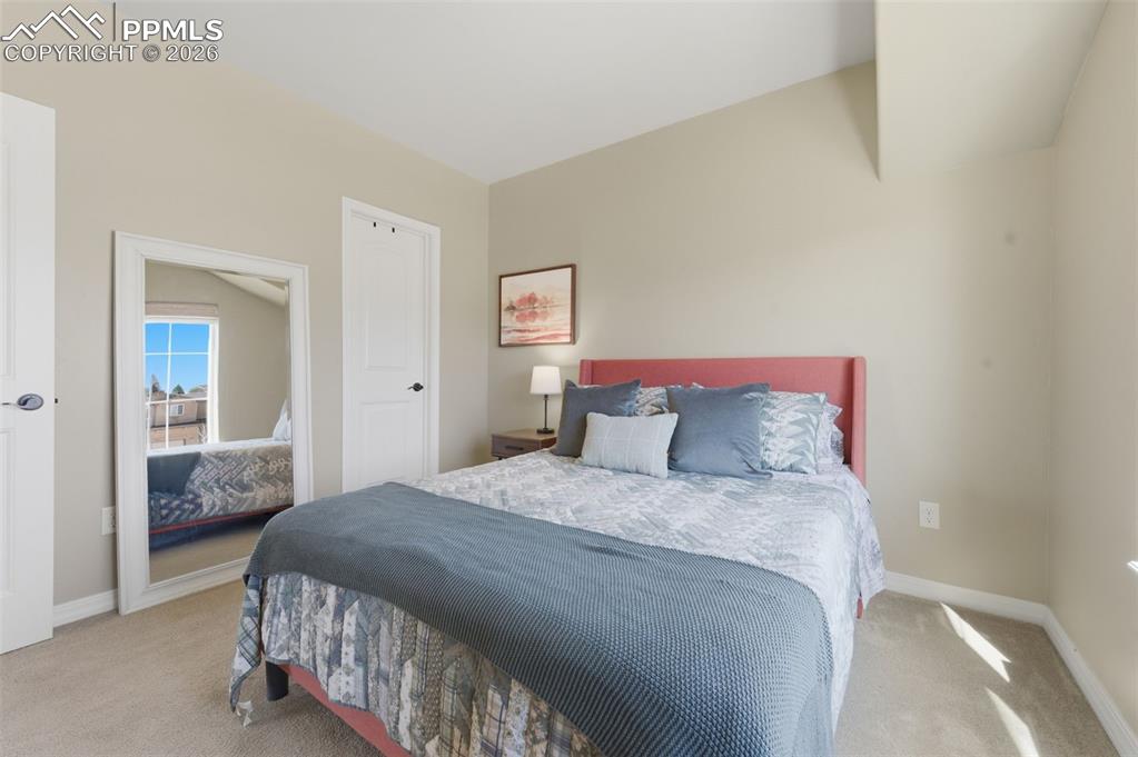 Image 29 of 50: Bathroom with a stall shower, double vanity, a walk in closet, and light ti