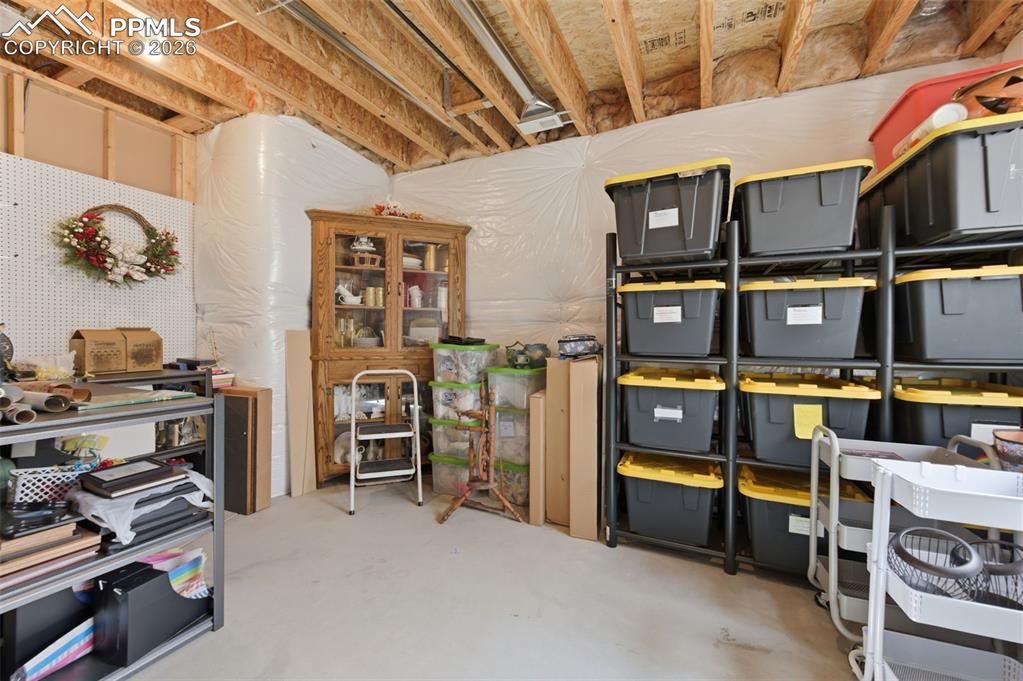 Image 36 of 50: Living area with light colored carpet and recessed lighting