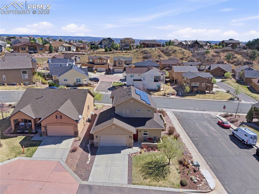 Image 43 of 50: View of front of house featuring stone siding, an attached garage, and stuc