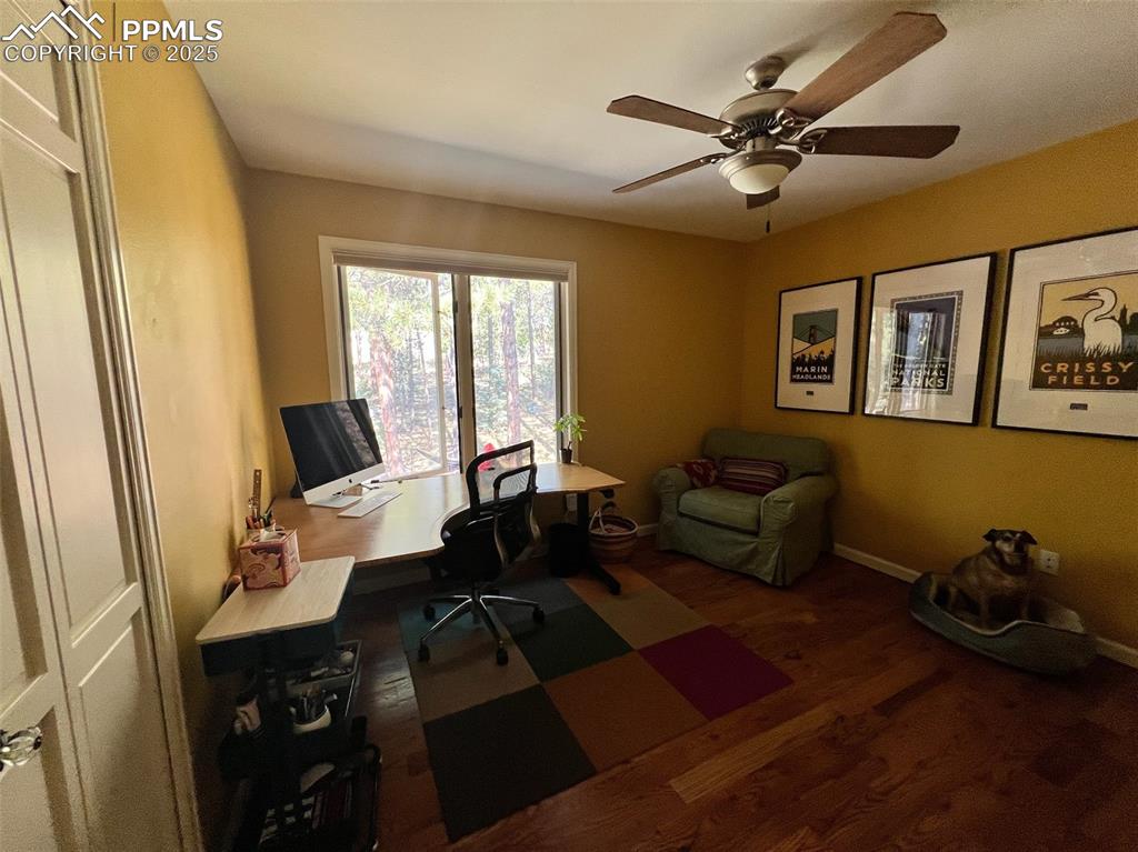 Image 25 of 49: Office space featuring wood finished floors, a ceiling fan, and baseboards