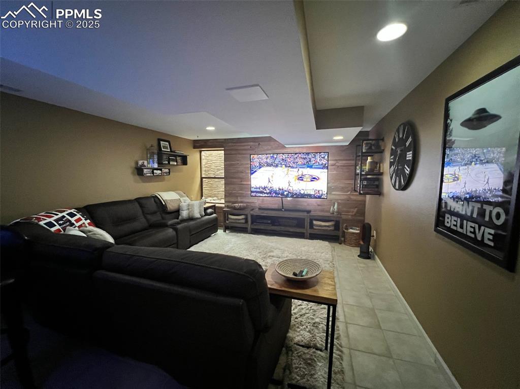 Image 28 of 49: Home theater room featuring tile patterned floors, recessed lighting, woode