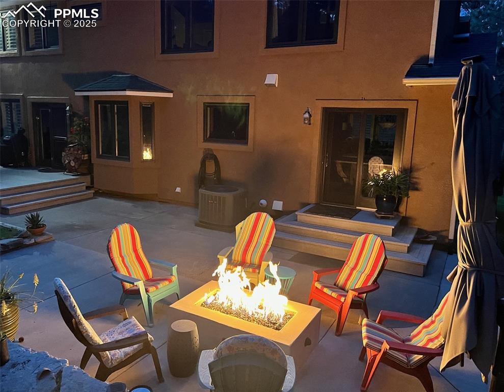Image 39 of 49: View of patio featuring a fire pit