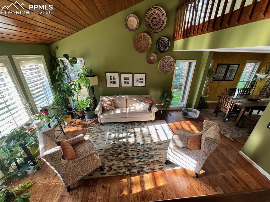 Image 5 of 49: Living room with vaulted ceiling, wood finished floors, and wood ceiling