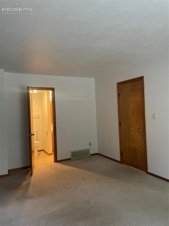Image 12 of 35: main level bedroom opens to full bath.