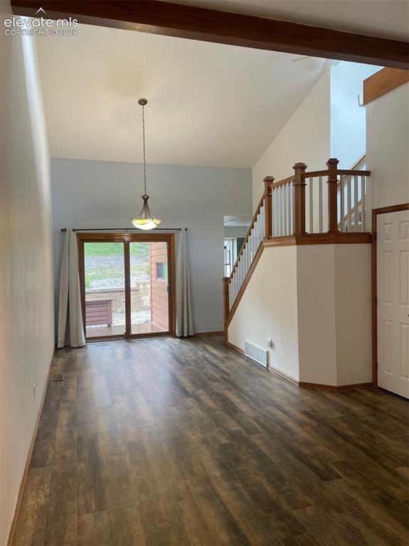 Image 2 of 35: View from living room back to dining room and back deck. Stairway leads to