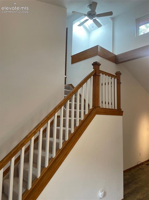 Image 20 of 35: Stairway leading to upper level bedroom and bath.
