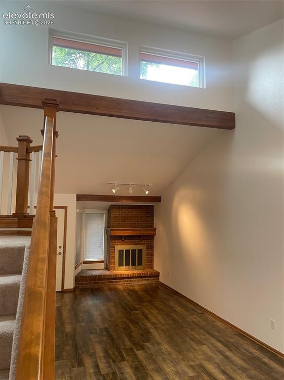 Image 3 of 35: view of living room with wood burning fireplace.