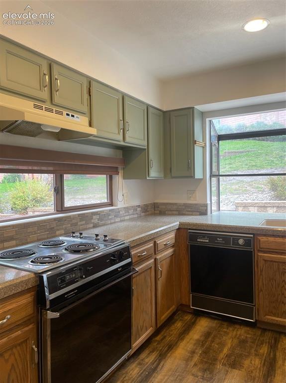 Image 4 of 35: Kitchen looks onto rear open space and deck area.