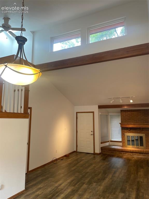 Image 8 of 35: View from dining room to living room and front door entry. High windows let