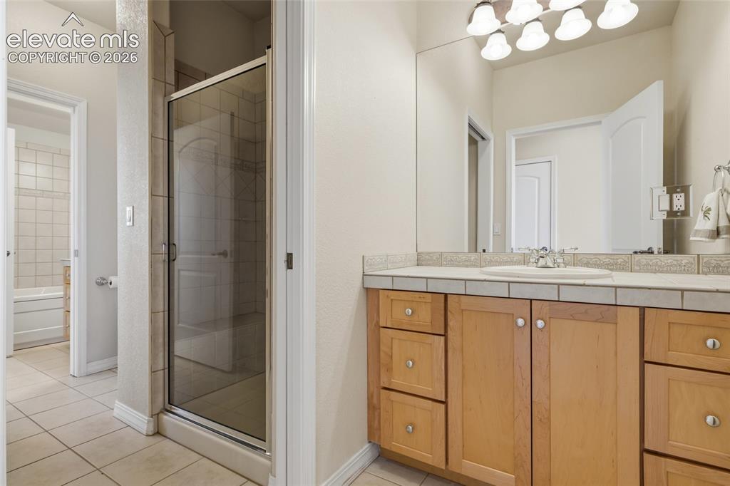 Image 40 of 50: Wall-to-wall carpeting and white walls complement the recessed lighting and