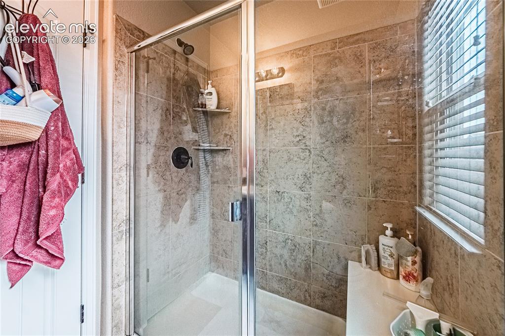 Image 17 of 36: Full bathroom featuring a shower stall