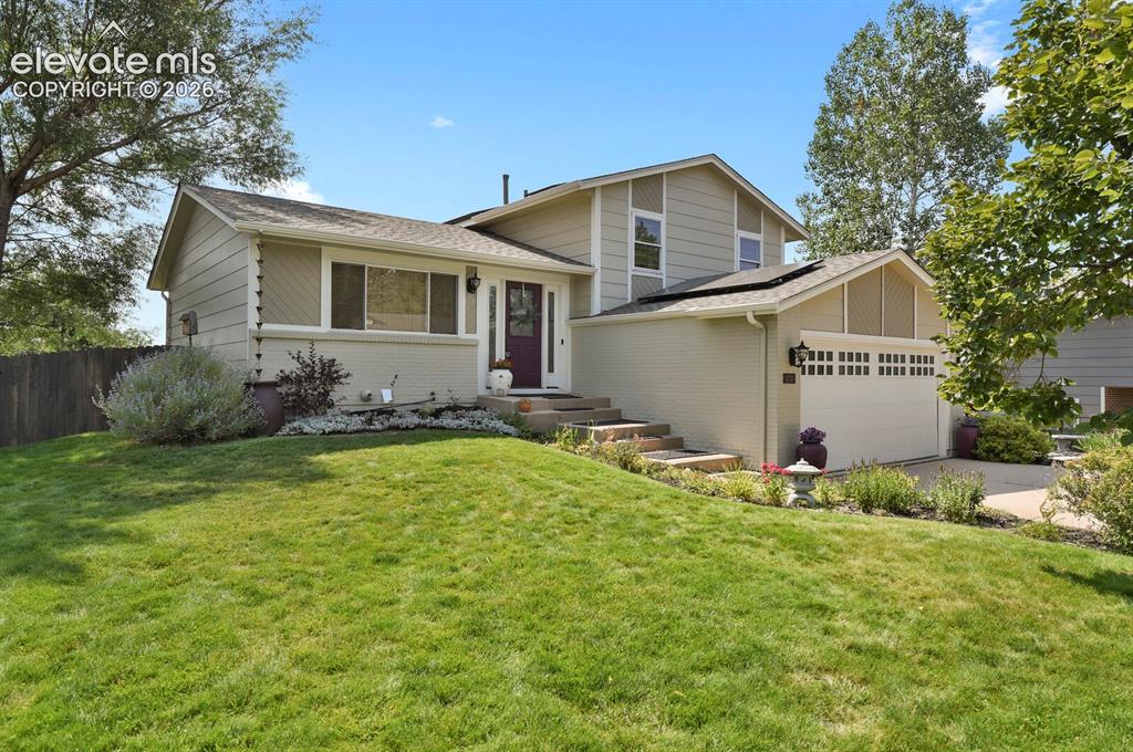 Caption: Two-story residence featuring a two-car garage, pitched roof, and a prominent front entrance