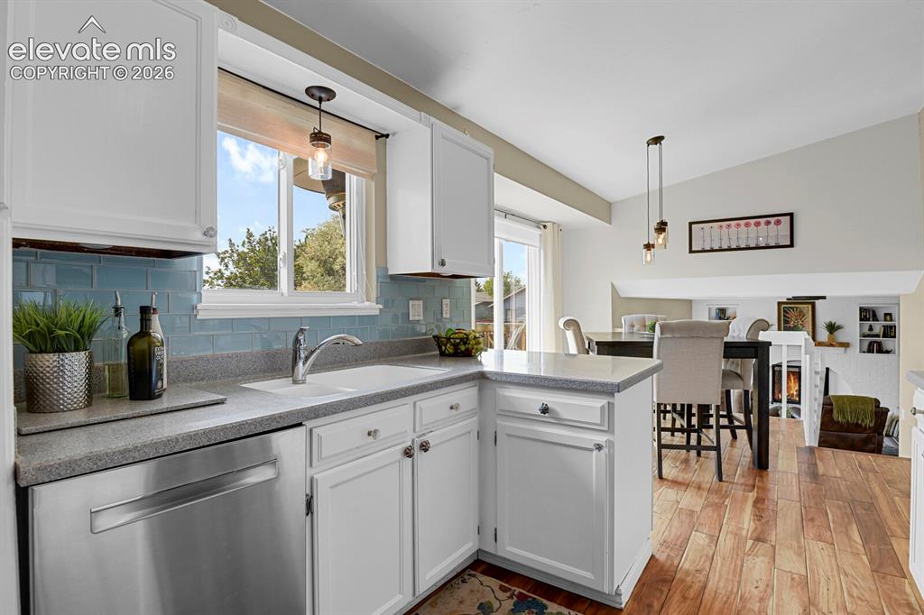 Image 13 of 38: Kitchen featuring white cabinetry, light-toned countertops, a stainless ste