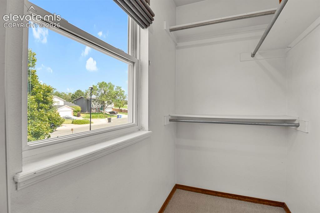 Image 16 of 38: Built-in shelving with hanging rods