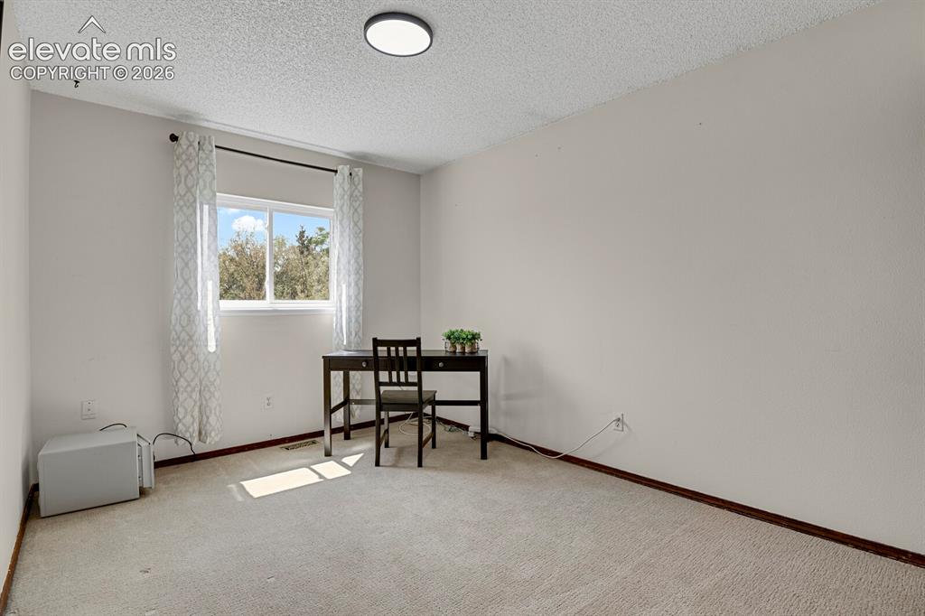 Image 18 of 38: Light-filled room featuring a single window and recessed lighting