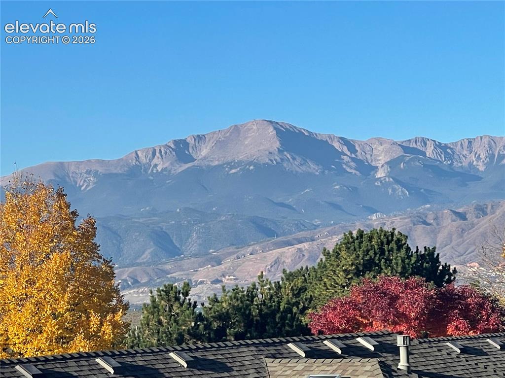 Image 38 of 38: Mountain backdrop with clear skies and a shingle roof