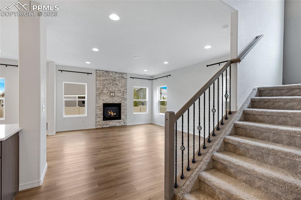 Image 12 of 50: Stairway featuring wood finished floors, recessed lighting, baseboards, and