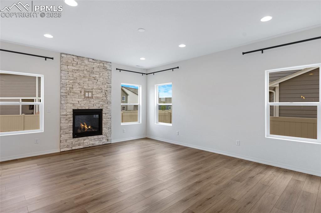Image 13 of 50: Unfurnished living room featuring wood finished floors, recessed lighting,