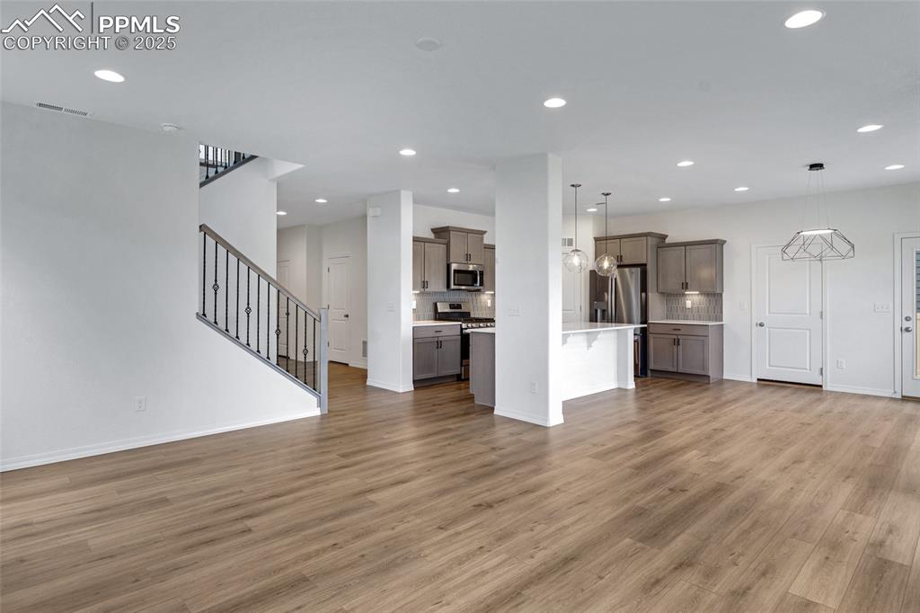 Image 14 of 50: Unfurnished living room featuring light wood-style flooring, recessed light