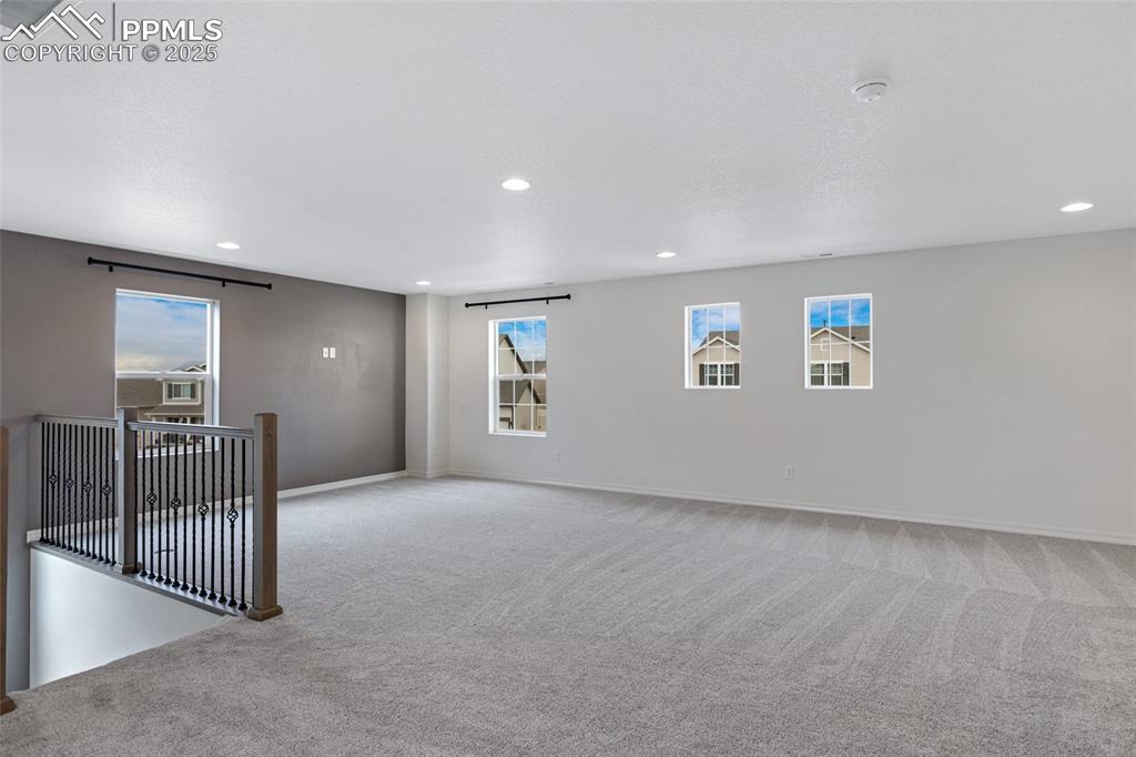 Image 21 of 50: Carpeted spare room featuring recessed lighting, baseboards, and a smoke de