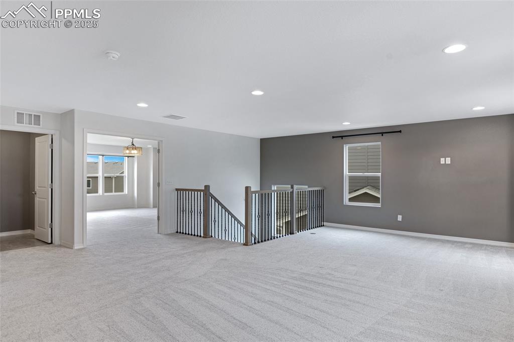 Image 23 of 50: Unfurnished room with light colored carpet, recessed lighting, baseboards,