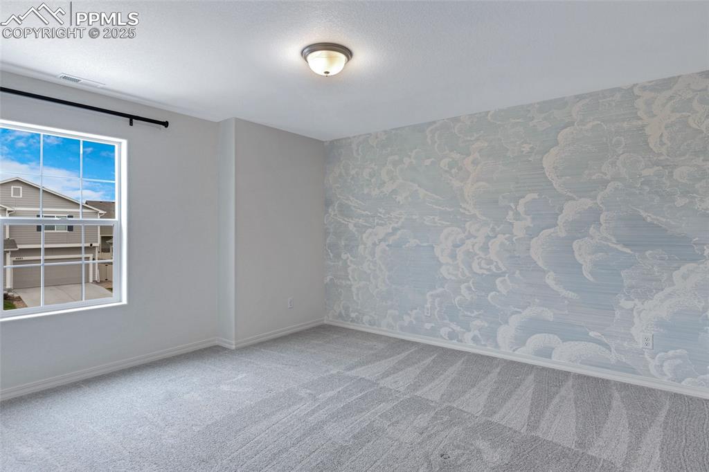 Image 24 of 50: Empty room with carpet flooring and baseboards