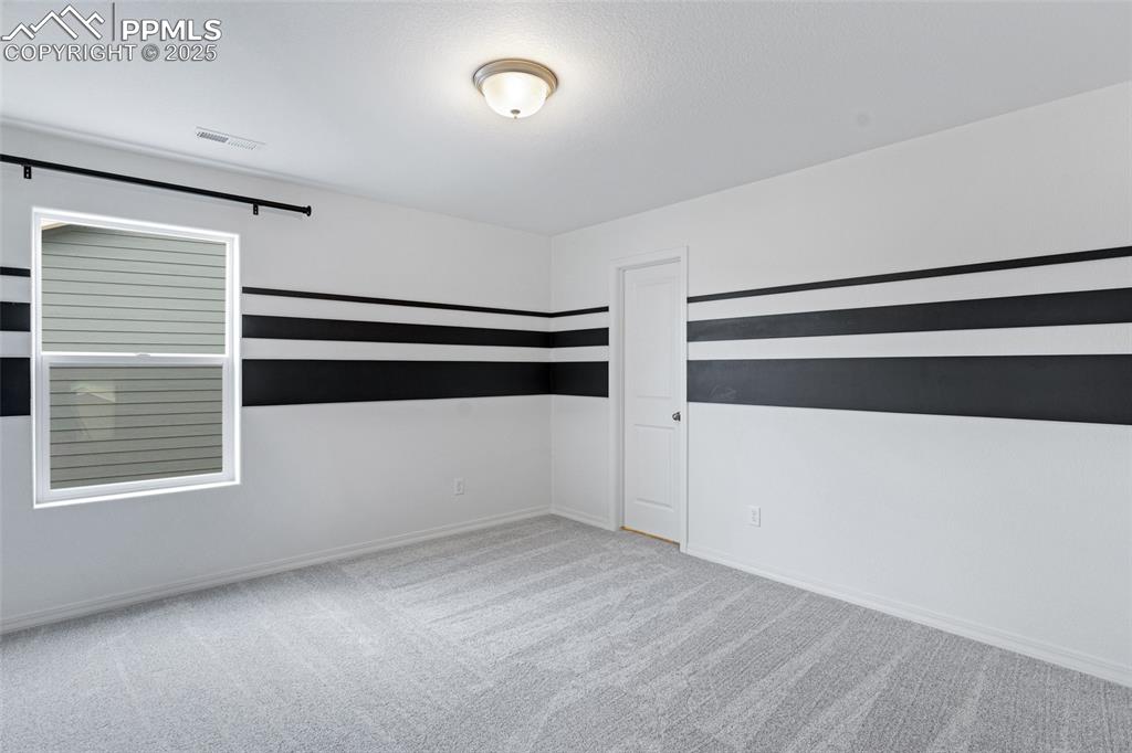 Image 27 of 50: Spare room with carpet floors and baseboards