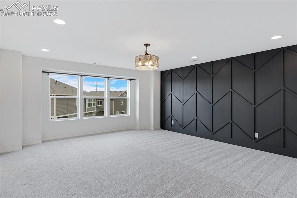 Image 30 of 50: Carpeted empty room featuring recessed lighting, a chandelier, and baseboar
