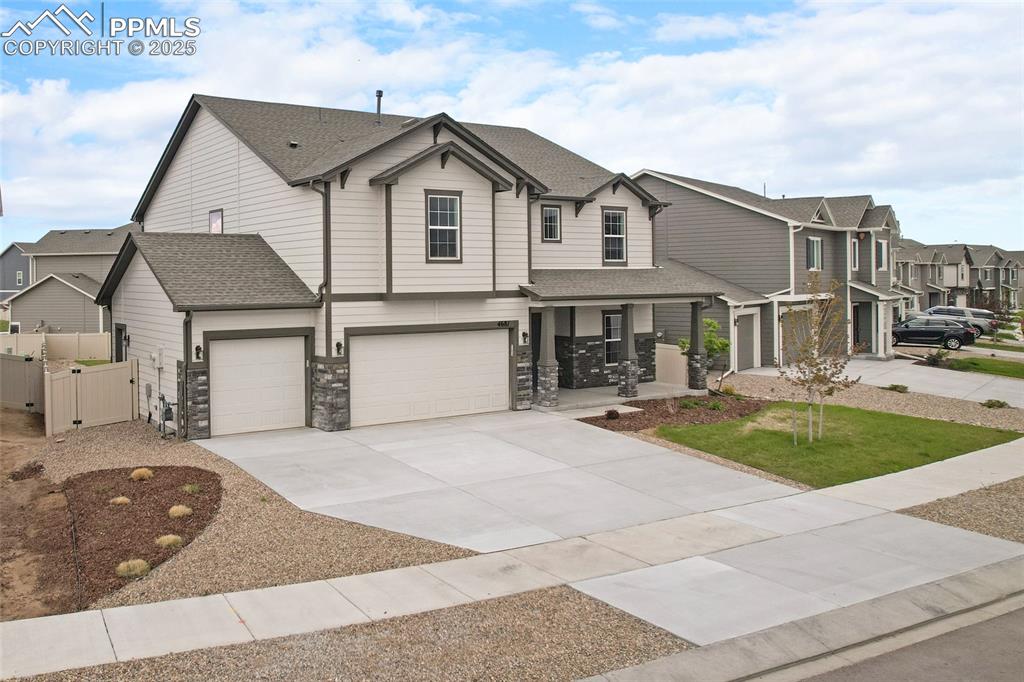 Image 4 of 50: View of front of home with a gate, concrete driveway, covered porch, a resi
