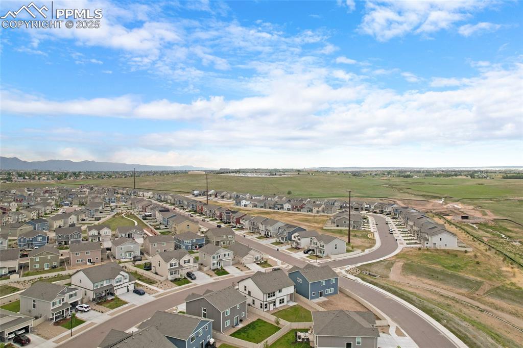 Image 46 of 50: Aerial view of residential area featuring mountains