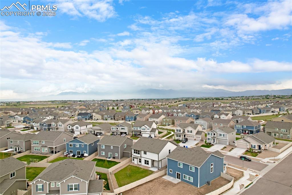 Image 47 of 50: Aerial view of residential area with a mountainous background