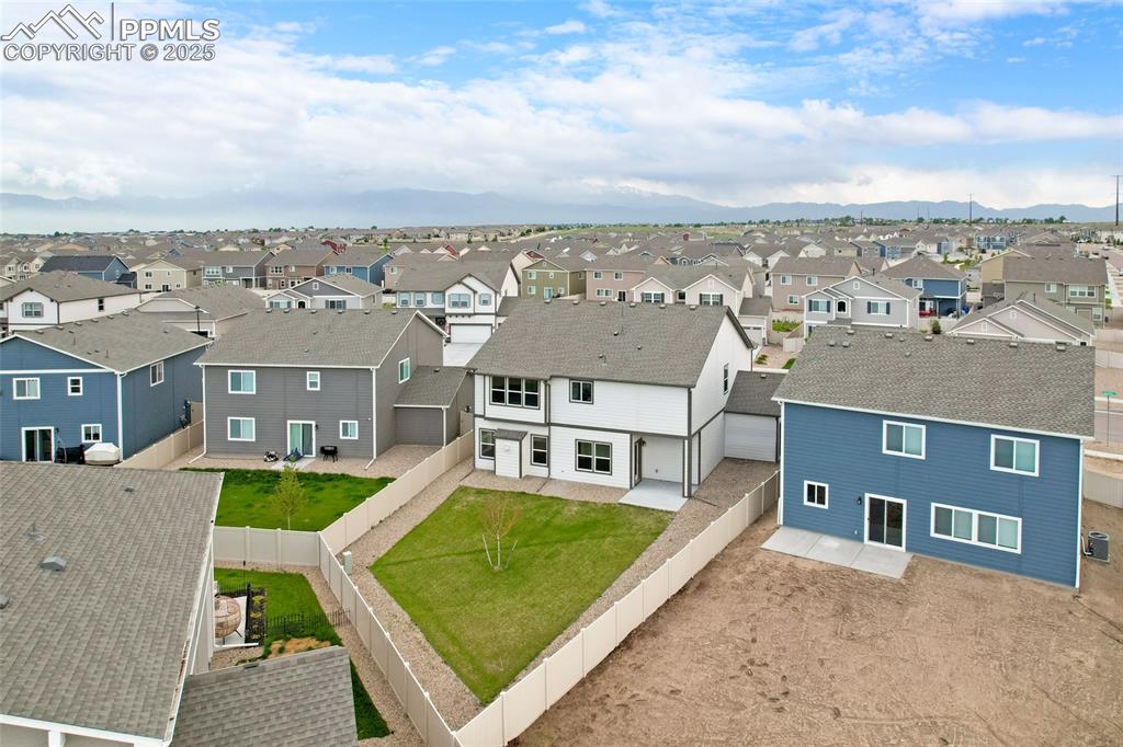 Image 49 of 50: Aerial perspective of suburban area with a mountainous background