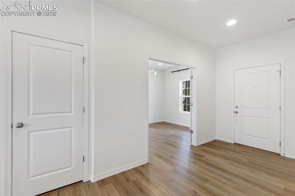 Image 9 of 50: Foyer with light wood-type flooring, baseboards, and recessed lighting