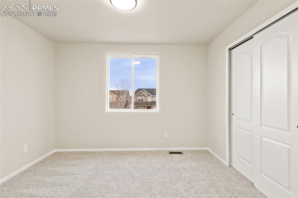 Image 19 of 27: Unfurnished bedroom with a closet and carpet floors