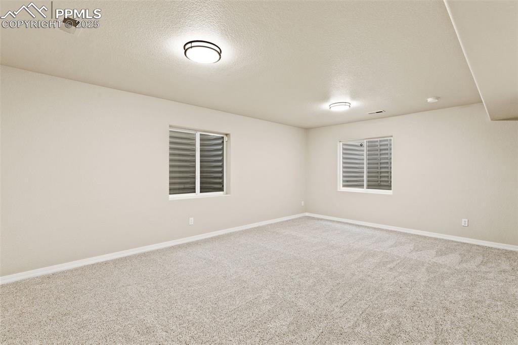 Image 24 of 27: Empty room featuring carpet floors and a textured ceiling