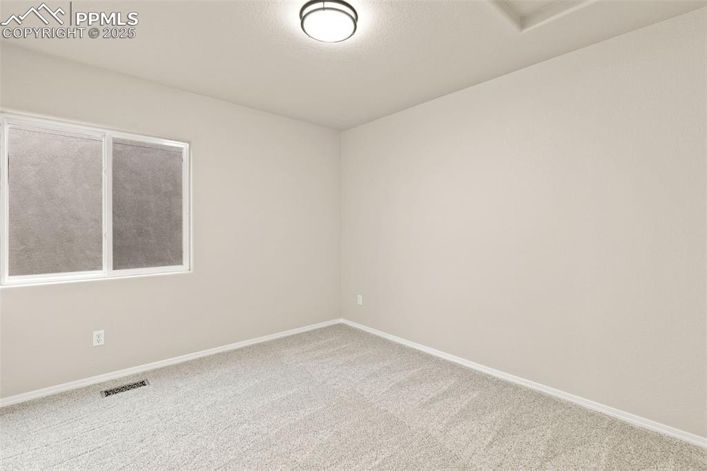 Image 26 of 27: Carpeted spare room featuring baseboards