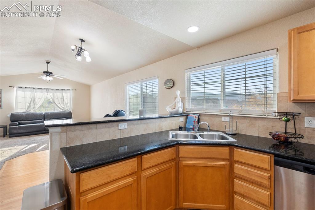 Image 19 of 46: Kitchen featuring open floor plan, dishwasher, vaulted ceiling, healthy amo