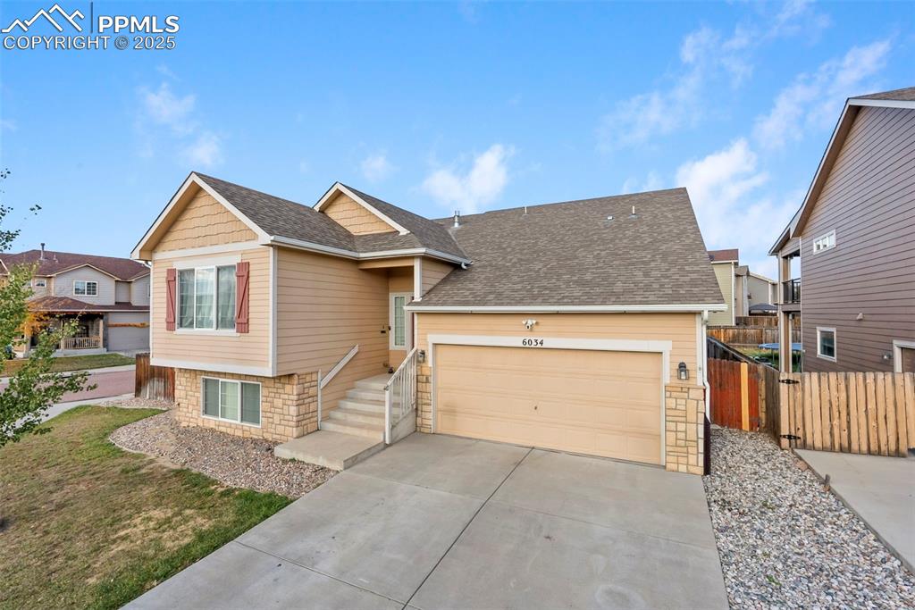 Image 5 of 46: View of front of property featuring stone siding, roof with shingles, drive