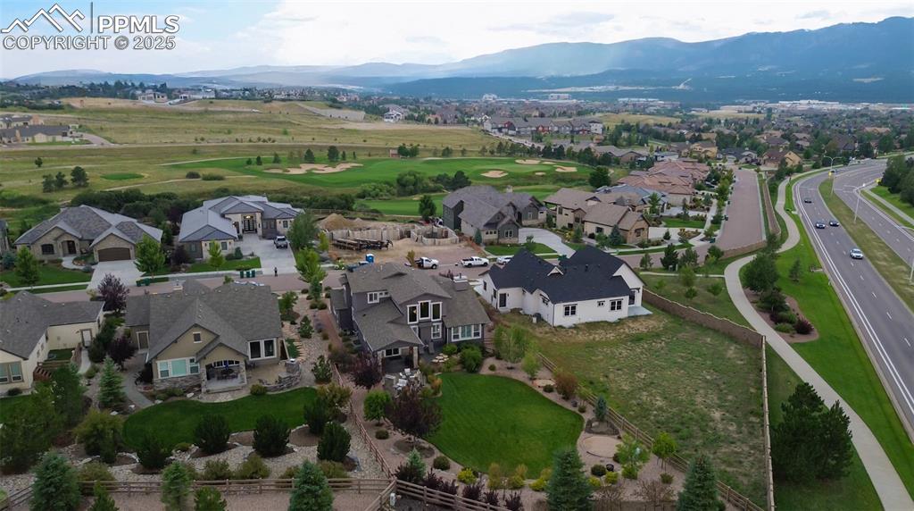 Image 41 of 50: Aerial view of home (middle/bottom) back yard closest with mountains