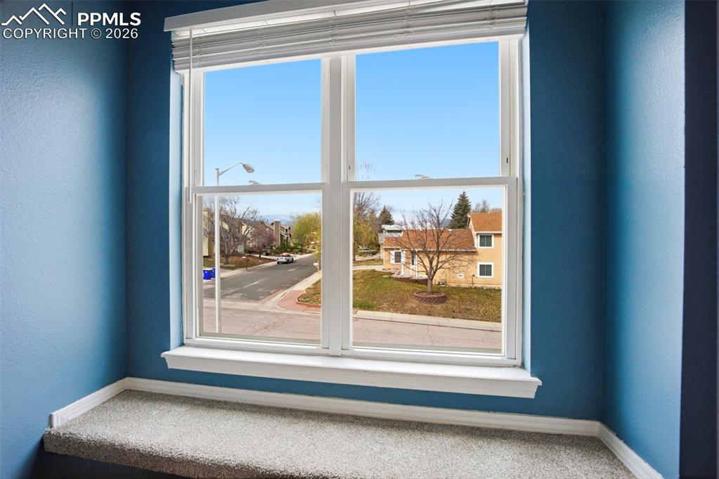 Image 17 of 46: Primary bedroom window with view of Pikes Peak