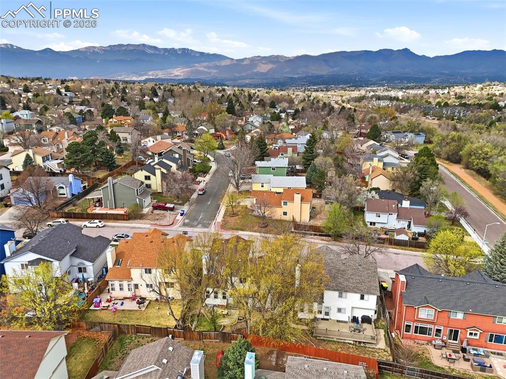 Image 2 of 46: Aerial perspective of suburban area featuring mountains
