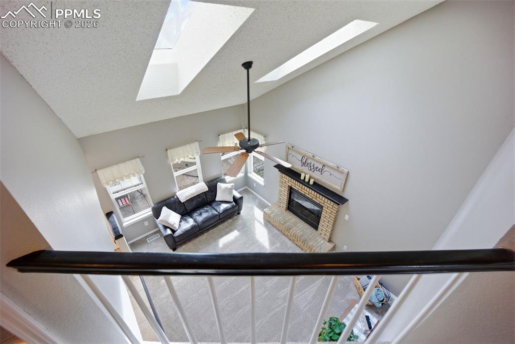 Image 28 of 46: Juliet balcony overlooking living room with two skylights
