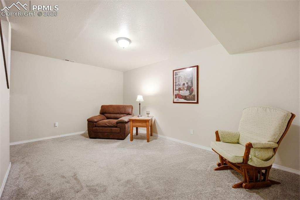 Image 29 of 46: Living area with light carpet