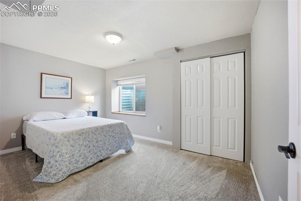 Image 30 of 46: Bedroom featuring a closet and light colored carpet