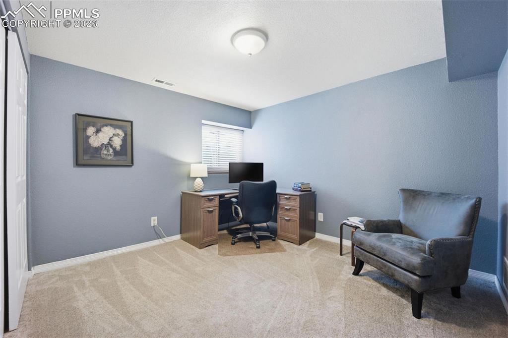 Image 32 of 46: Office with light colored carpet and baseboards