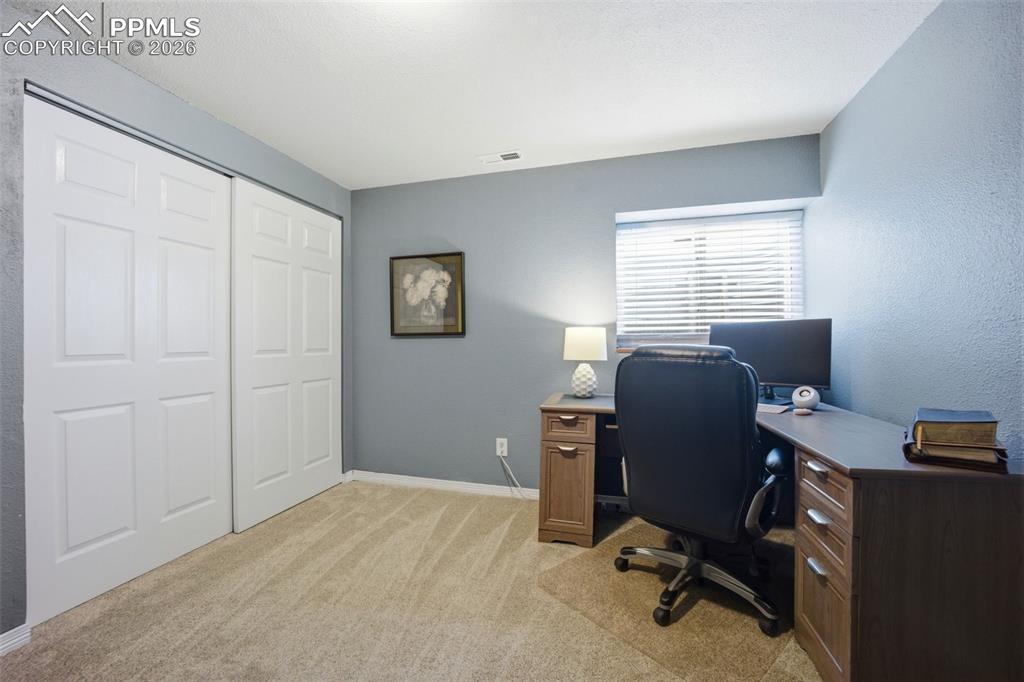 Image 33 of 46: Office featuring light colored carpet and baseboards